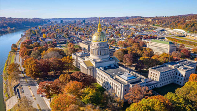 Aerial view of the West Virginia state capital building in the fall next to a river