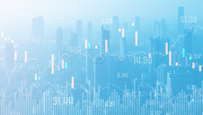 financial charts projected on a hazy image of a city skyline